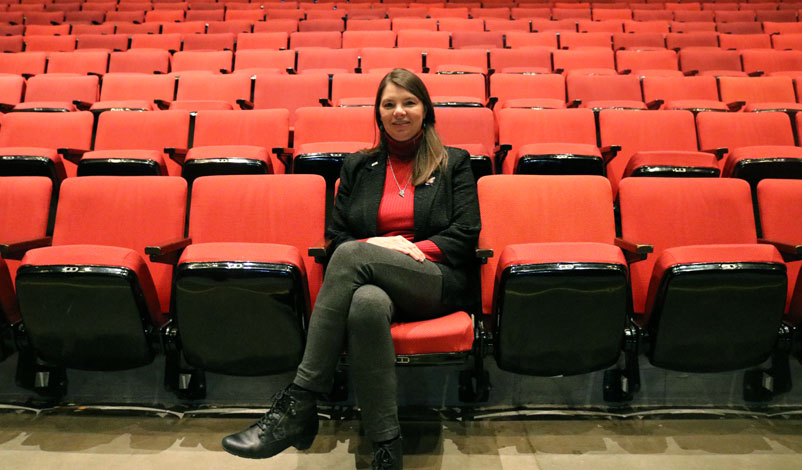 Tammy Koolbeck seated inside of Stephens Auditorium, Ames, Iowa.