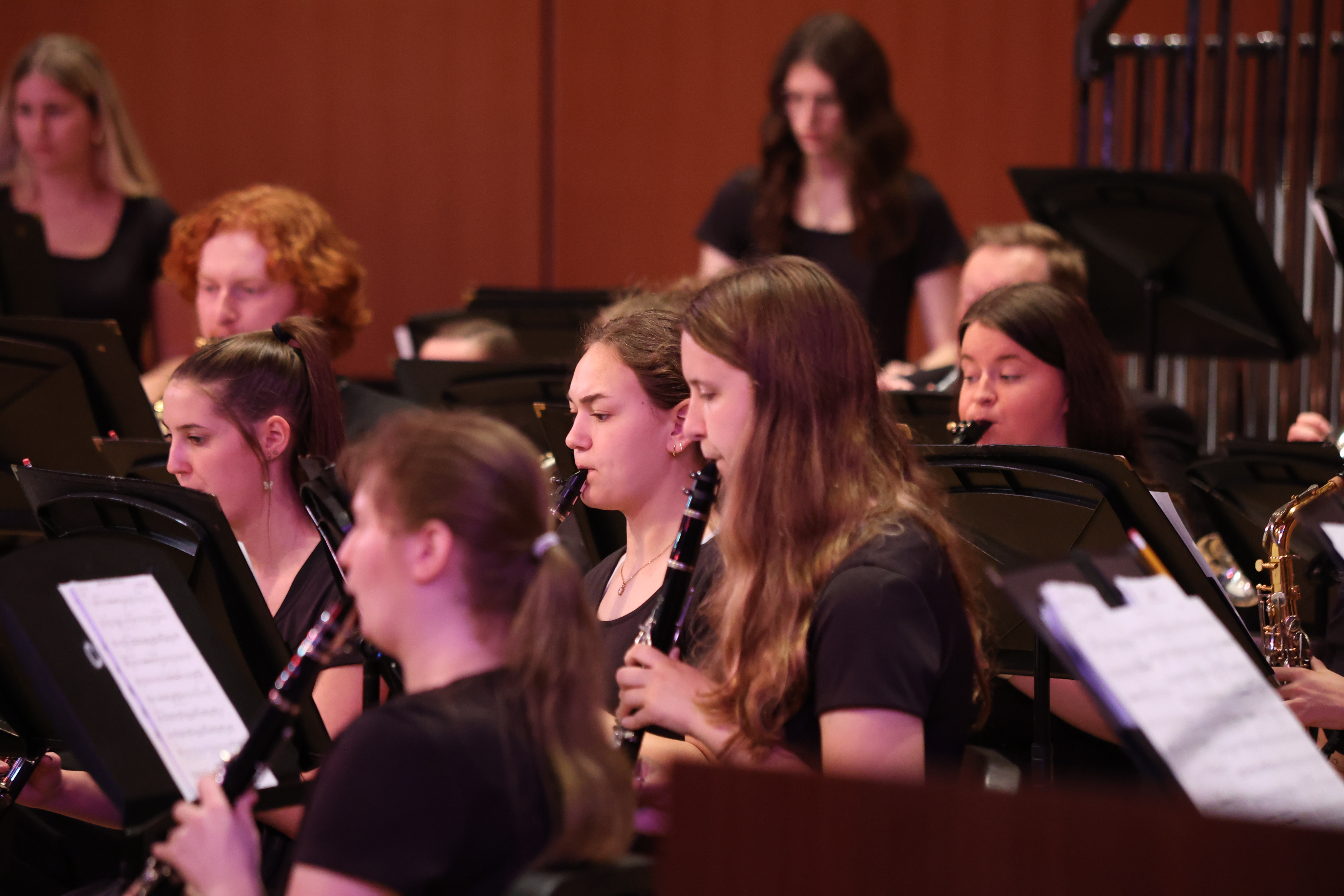Choir students playing instruments at a concert.