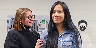 A DNP student working with a practice patient