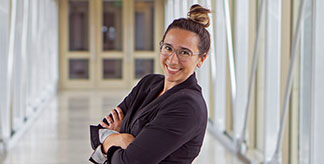 a woman, posing in her workplace