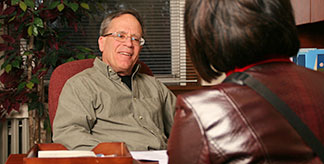 A man speaking to a woman across a desk