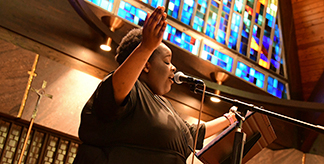 A woman singing in the Chapel of Mercy at Mount Mercy University