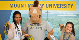Mustang Sally posing with Mount Mercy students