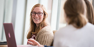 A Mount Mercy student talking with friends in the university center