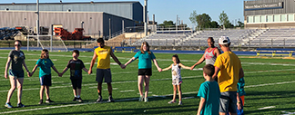 Kids holding hands at the Plaster Athletic Complex