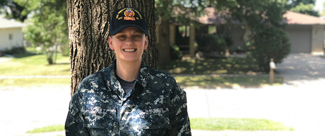 Dana Schultz, standing in her Navy uniform