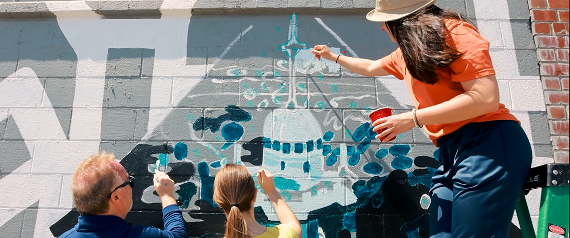 Mount Mercy students painting a mural of the Warde Hall cupola