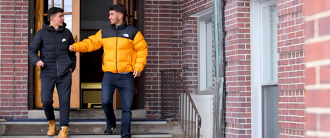 Two students talking outside of Warde Hall