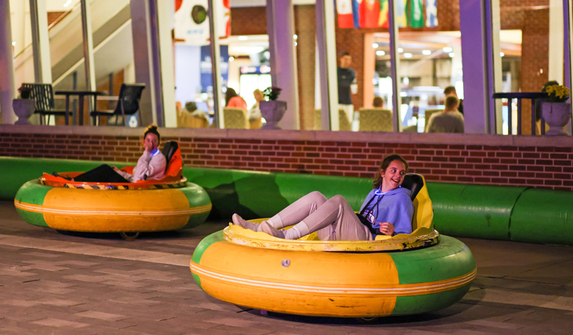 Students enjoying bumper cars during a campus event