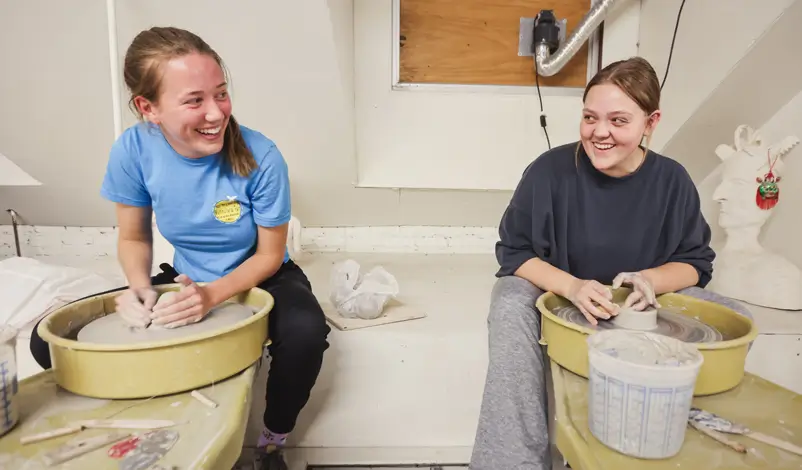 students doing pottery