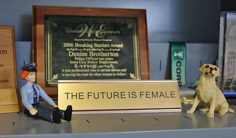 A sign on a bookshelf, reading "The future is female."