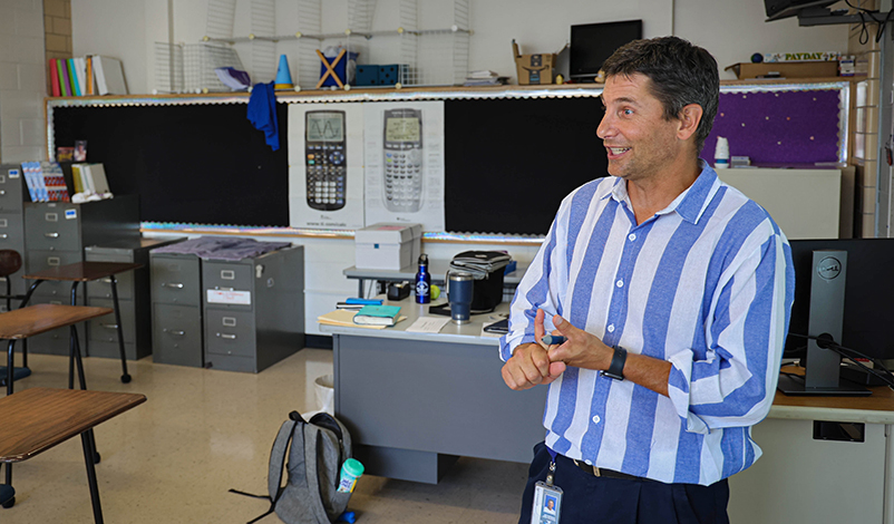 Terry, talking to rows of desks in his classroom 