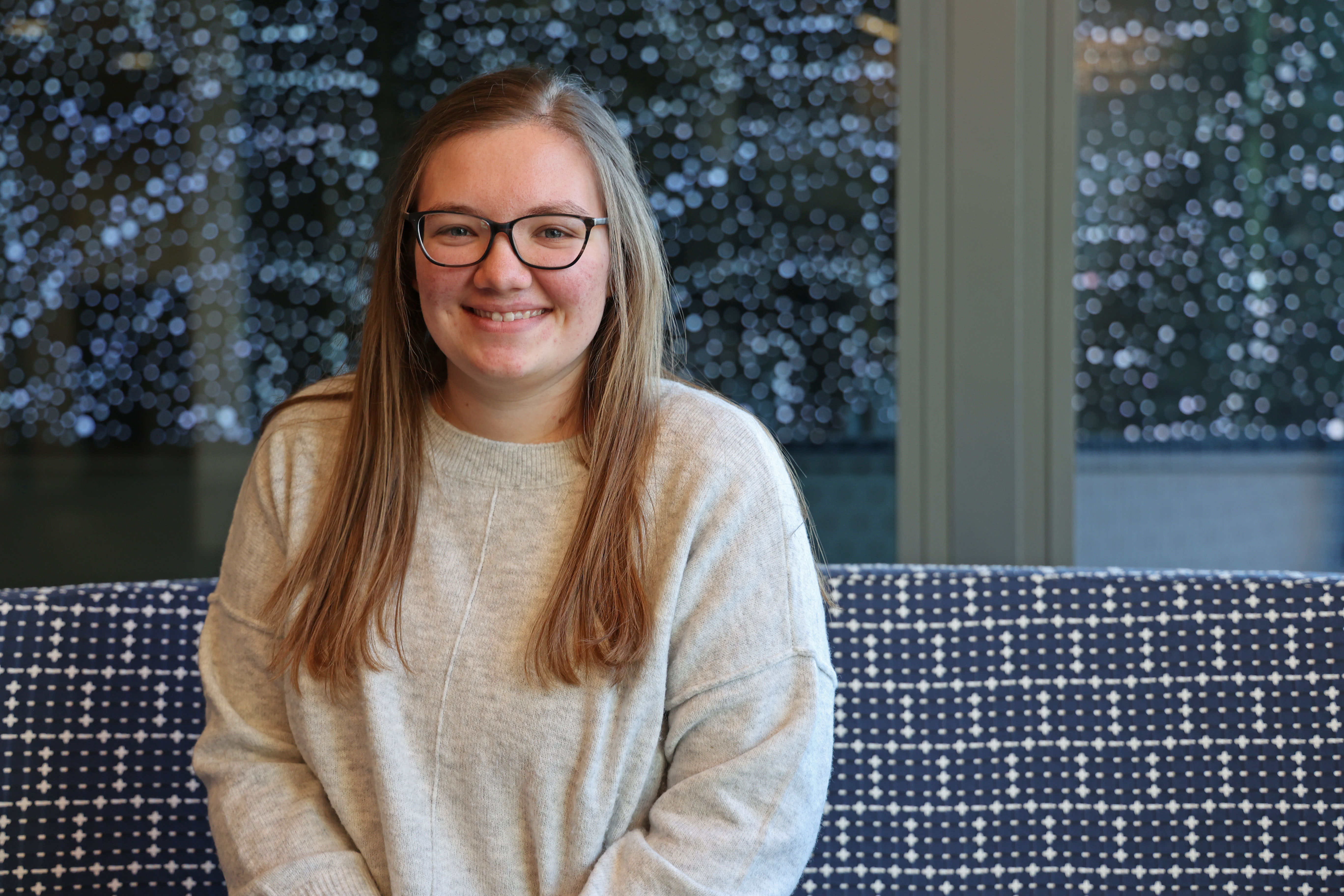 Jullian, posing for a photo at the site of her marketing internship in Cedar Rapids