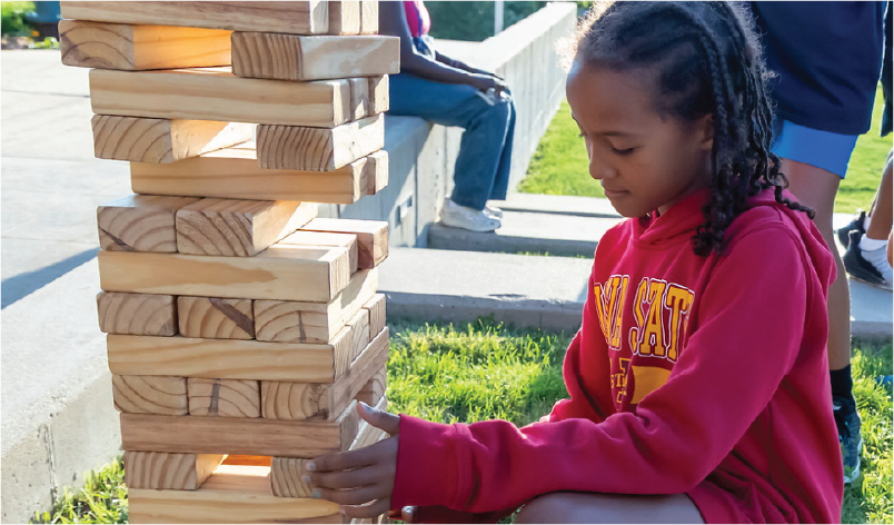 Jumpstart student playing Jenga.
