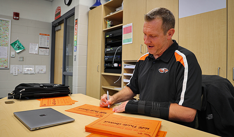 Brad Koch signing Hill Pride Award Certificates