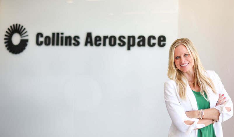 Crystal posing in front of Collins Aerospace