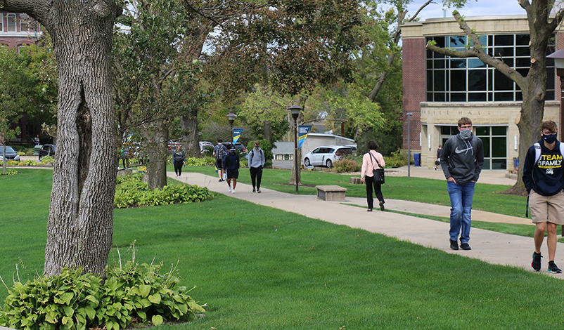 Masked students walking to classes