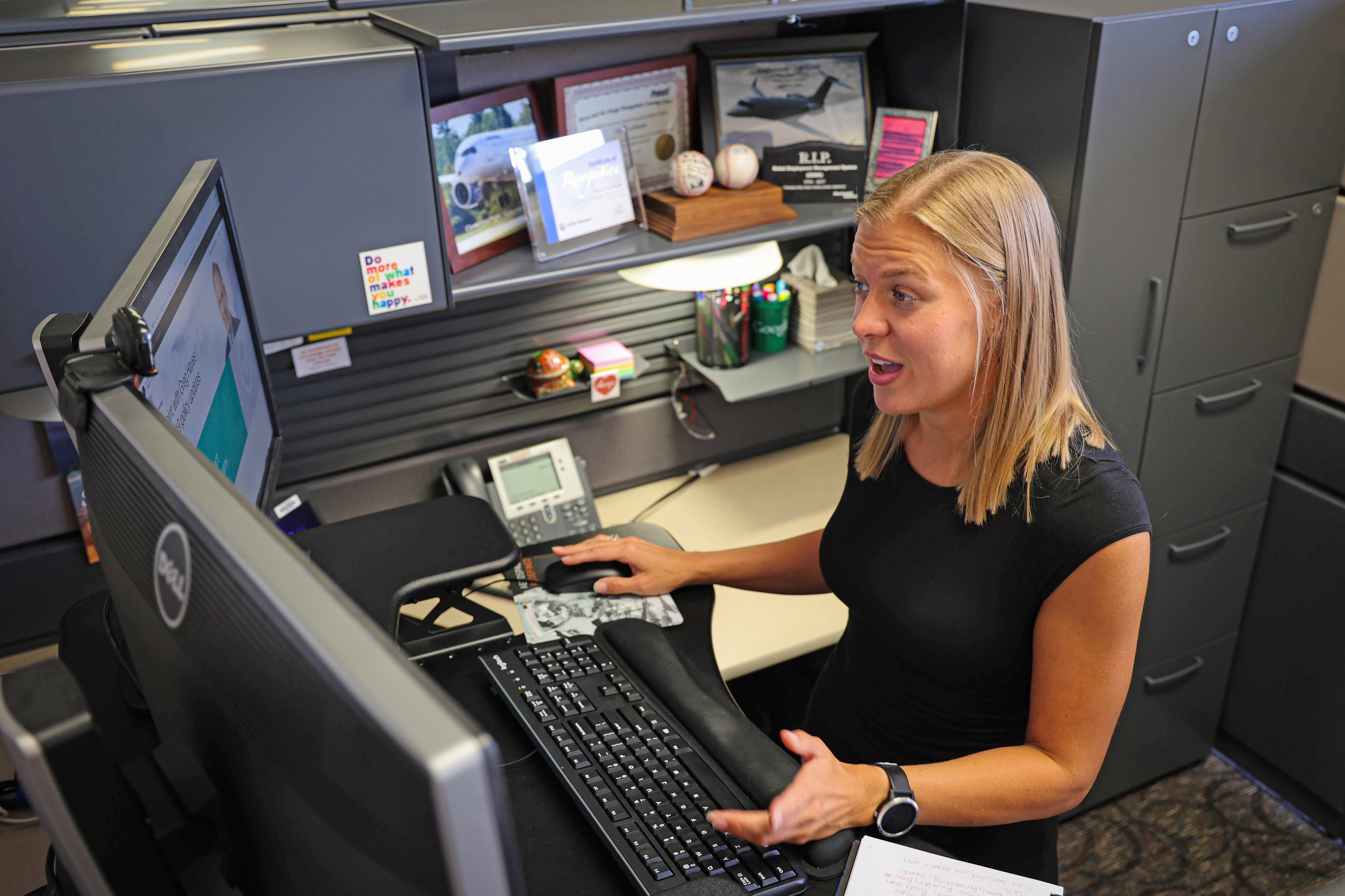 Piper, talking and sitting at her desk