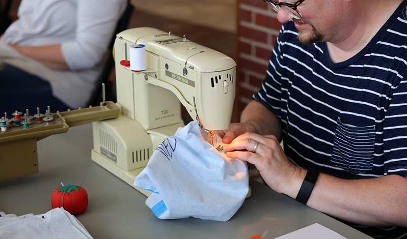 a man using a sewing machine