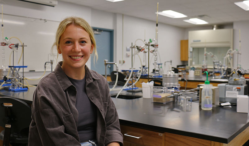 Peyton in the chemistry lab, smiling for the camera