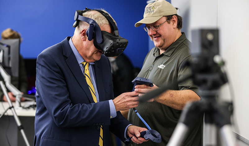 Mount Mercy President, Dr. Todd A. Olson, demonstrates virtual reality equipment
