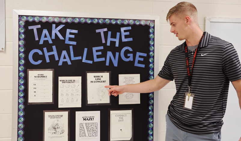 tyler kelley showing off a bulletin board