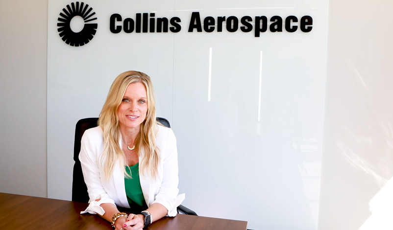 Collins Aerospace employee Crystal Loftsgard sitting at her desk
