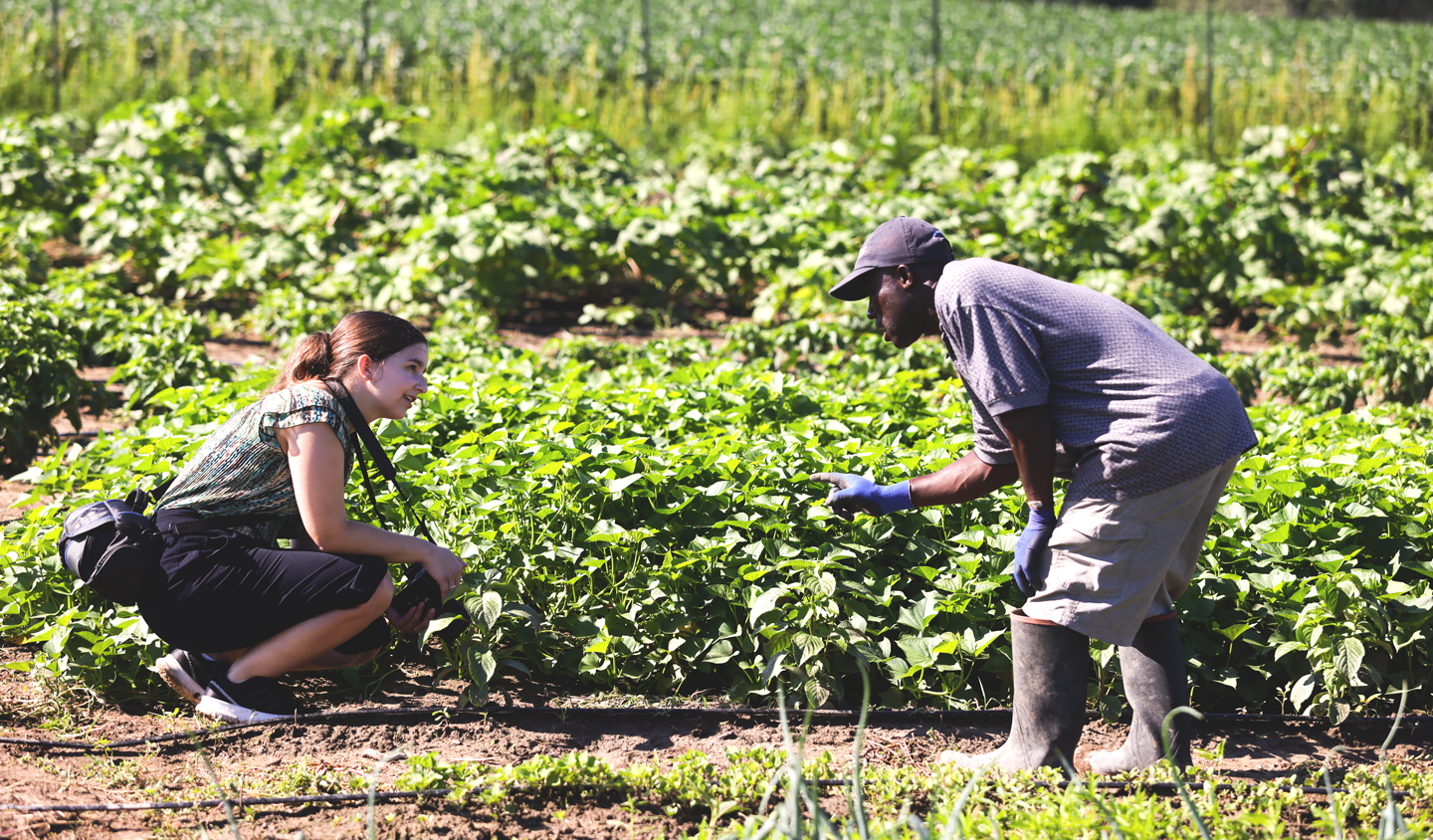 Darius Nupolu and Hallie Eickhoff posing in the middle of Dows Farm for Feed Iowa First