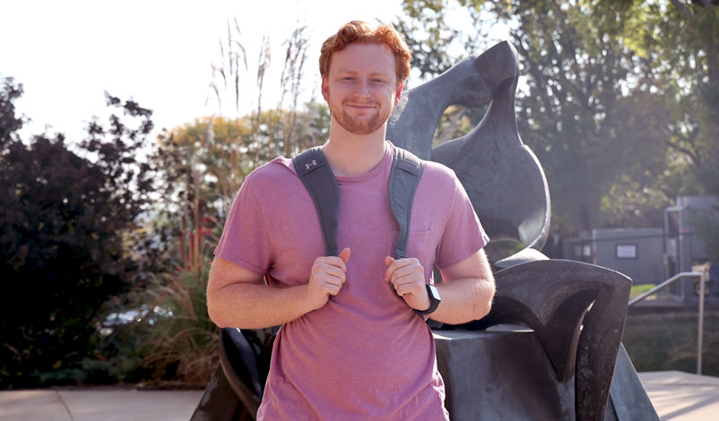 jonathan servey standing in the plaza at mount mercy university