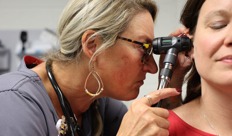 michelle bigger-wiegard checking patient's ears