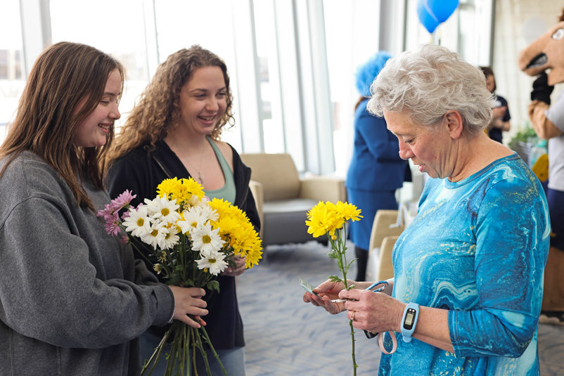 Students handing out flowers in the University Center