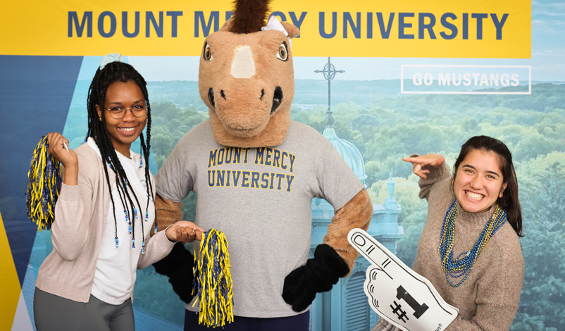 Students posing for a photo with Mustang Sally 