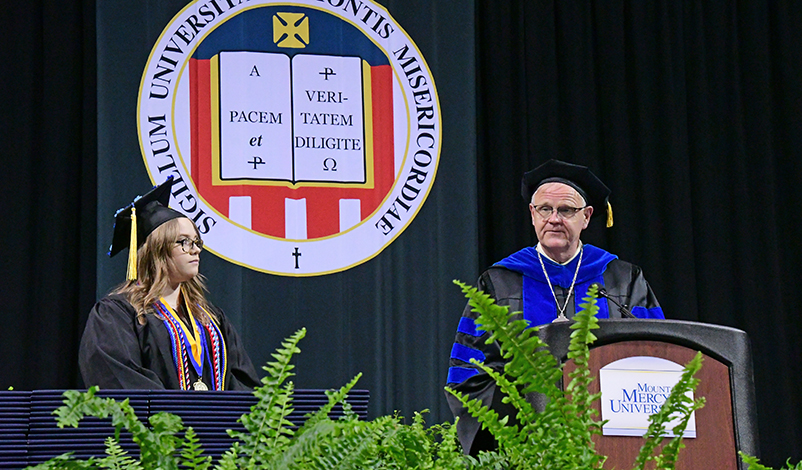 Emma Lantz and President Todd A. Olson on the Commencement stage