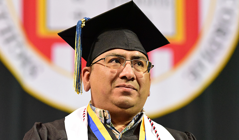 Marco Delgado on stage at Commencement