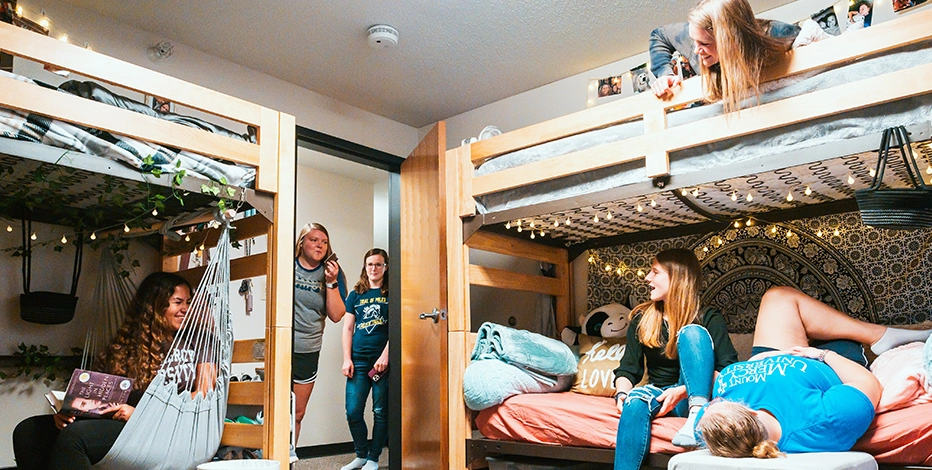 Students sit together in their on campus dorm room at Mount Mercy University.