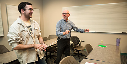 A music student and teacher conducting